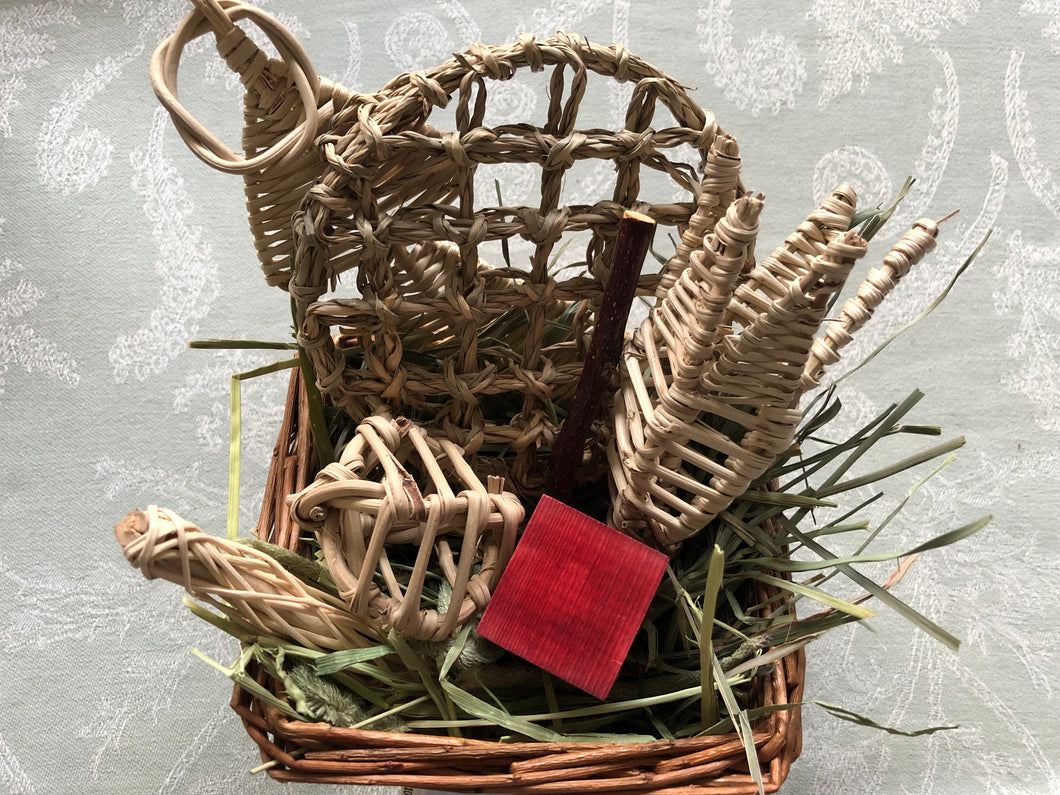 willow basket with additional chew toys and hay